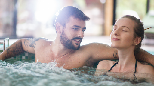 A couple relaxes in a bubbling hot tub