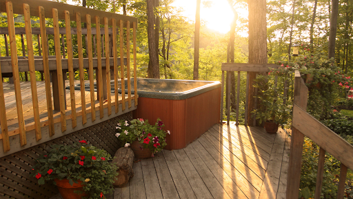 A hot tub on a pleasant balcony shines in the setting sun.