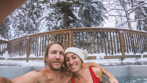 Couple enjoys their hot tub in winter.