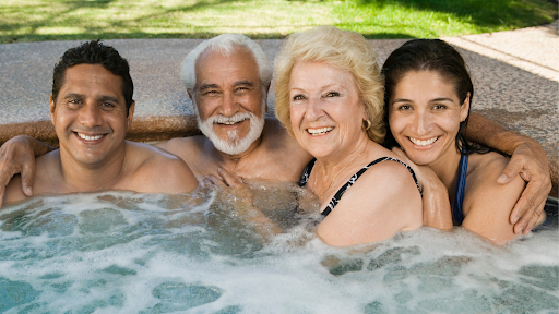 An older couple share their hot tub with their adult children.