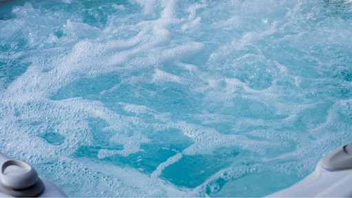 Close-up of turbulent, foamy water in a hot tub.